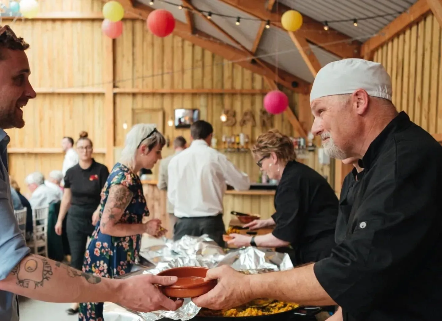 Buen Apetito team serving food to wedding guests